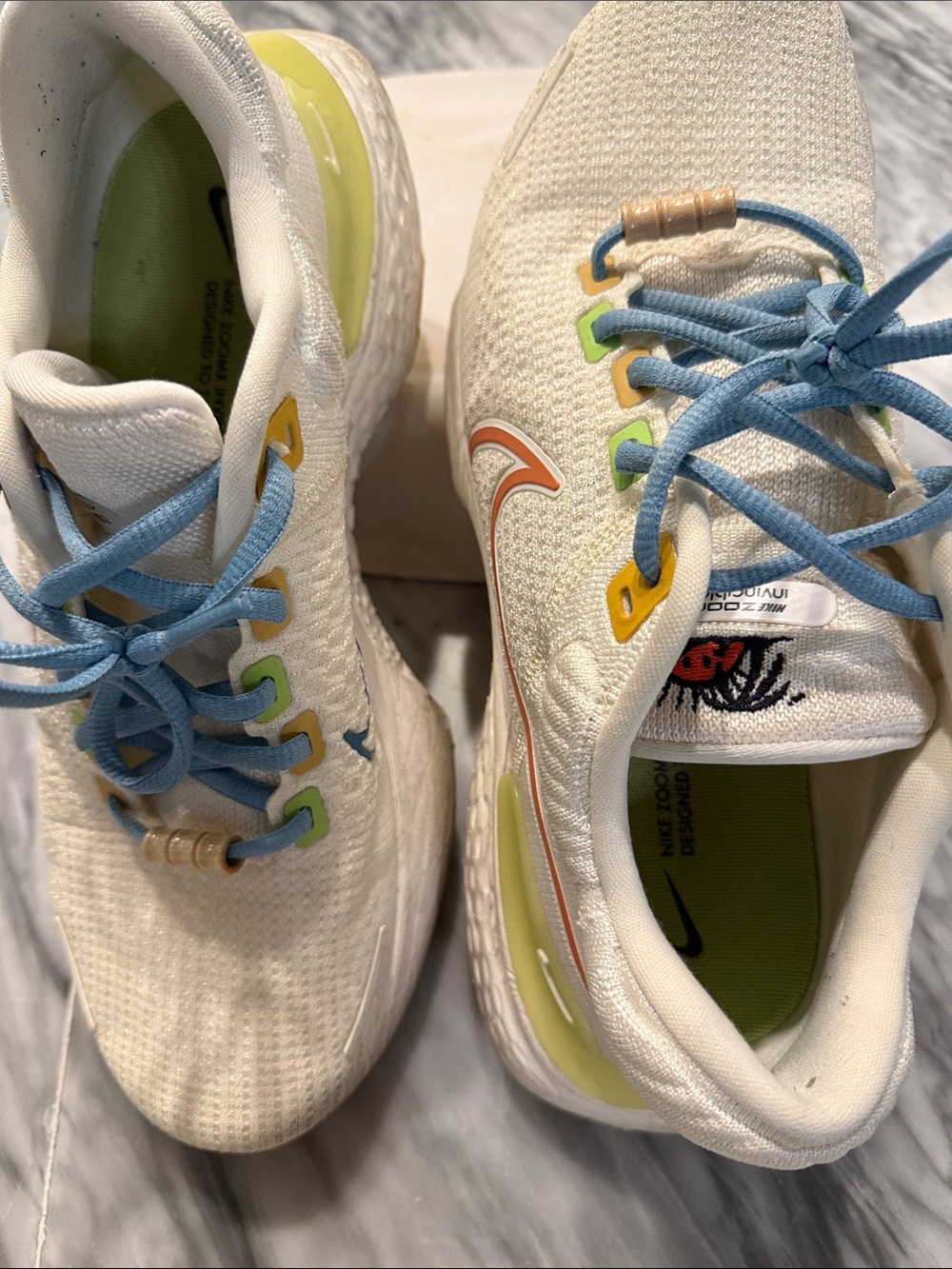Nike Cream Knit Athletic Sneakers with Blue Laces and Yellow Accents